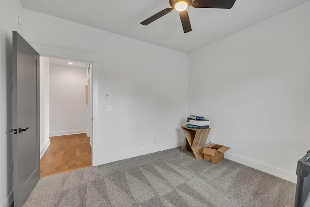 unfurnished room featuring ceiling fan and carpet floors