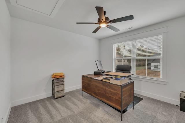 carpeted office space with ceiling fan