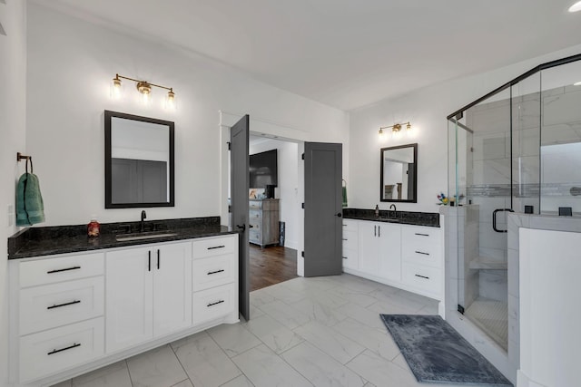 bathroom with vanity and a shower with door