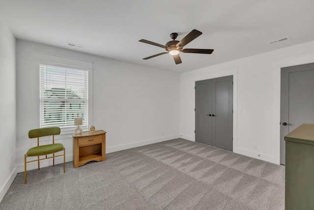 bedroom with ceiling fan, a closet, and light carpet