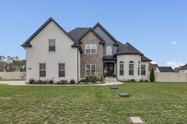 french country inspired facade featuring a front lawn