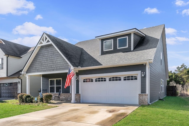 craftsman inspired home featuring a garage and a front yard