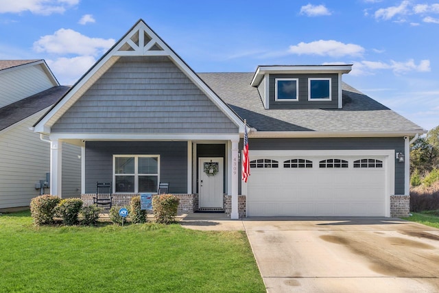 craftsman house featuring a porch, a front yard, and a garage