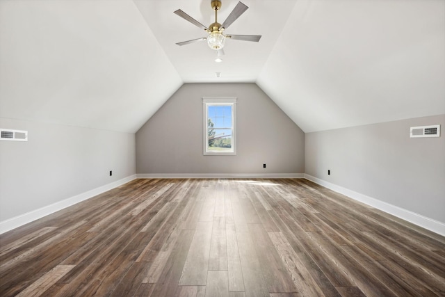 additional living space with ceiling fan, dark wood-type flooring, and vaulted ceiling