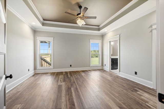 unfurnished living room with ceiling fan, crown molding, and a tray ceiling