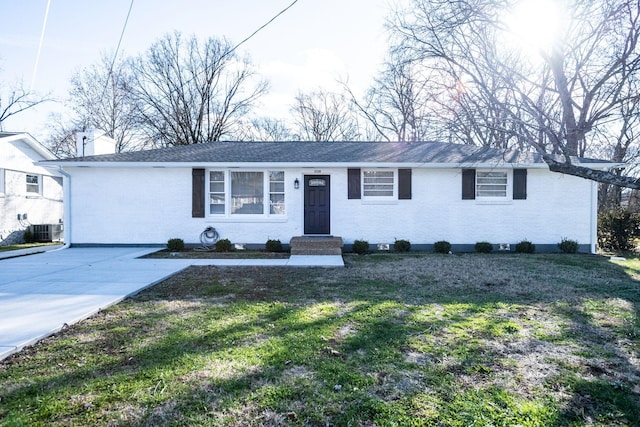 ranch-style house with a front lawn and cooling unit