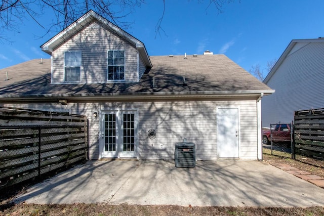 rear view of property with cooling unit and a patio