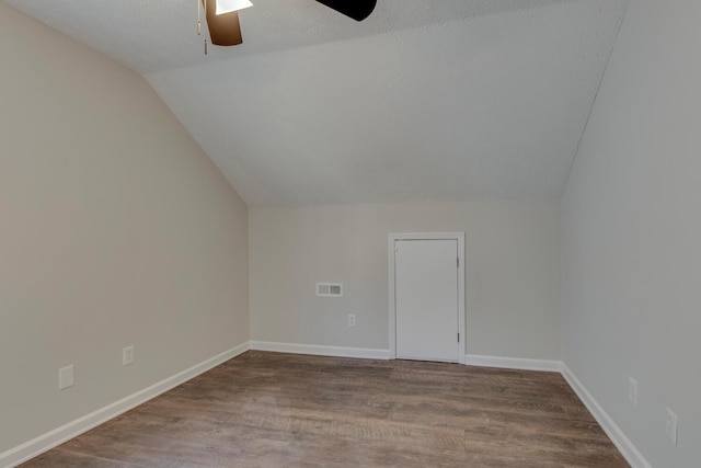 bonus room featuring wood-type flooring, a textured ceiling, ceiling fan, and lofted ceiling