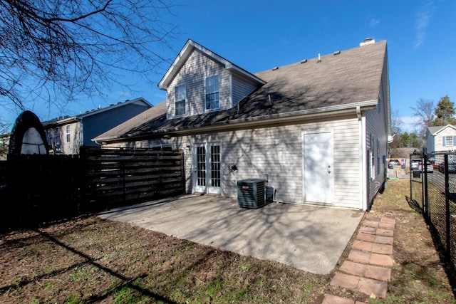 rear view of house featuring a patio area, french doors, and central AC