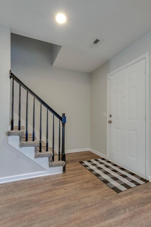 entrance foyer with hardwood / wood-style floors