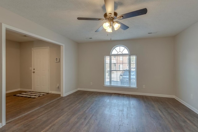 unfurnished room featuring a textured ceiling, dark hardwood / wood-style floors, and ceiling fan