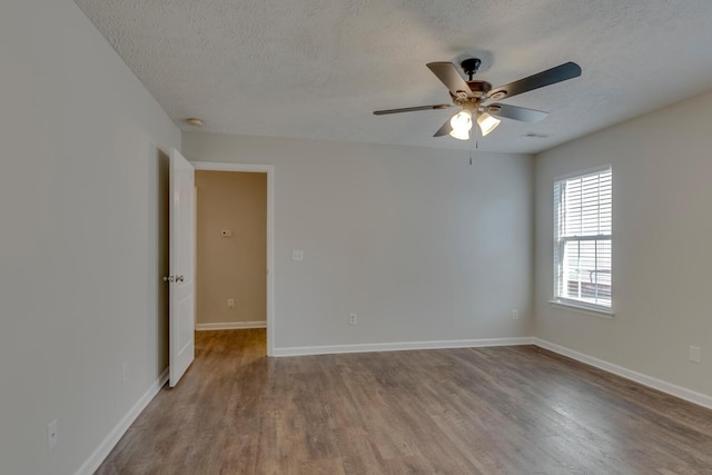 spare room with wood-type flooring, a textured ceiling, and ceiling fan