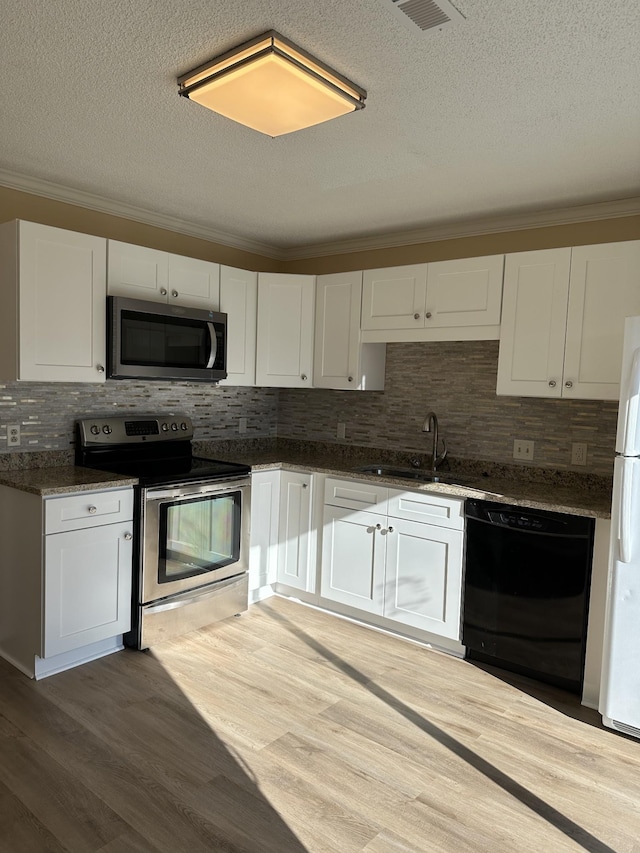 kitchen featuring white cabinets, appliances with stainless steel finishes, and a textured ceiling