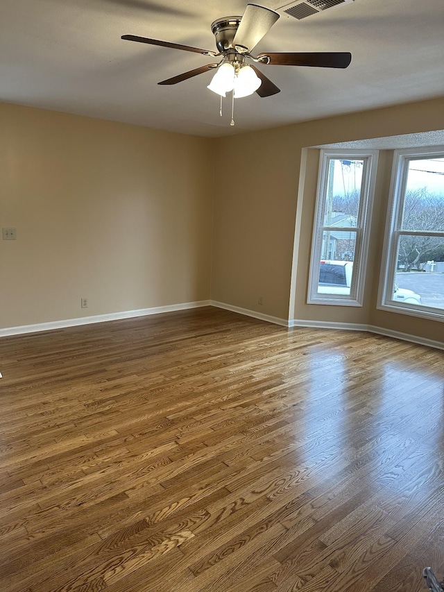 spare room with wood-type flooring and ceiling fan