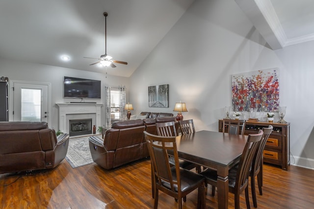 dining room with dark hardwood / wood-style floors, high vaulted ceiling, and ceiling fan