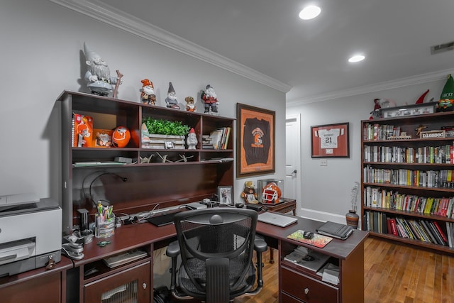 home office featuring hardwood / wood-style floors and crown molding