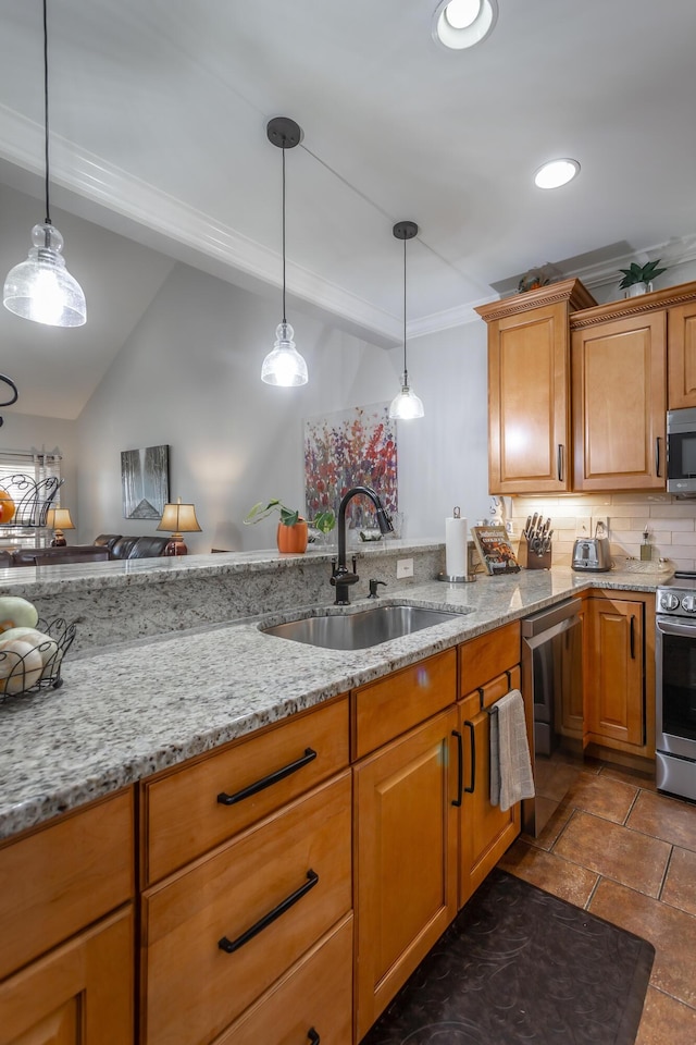 kitchen with hanging light fixtures, light stone countertops, sink, and stainless steel appliances