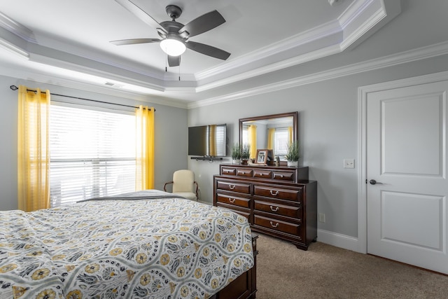 bedroom featuring light colored carpet, ceiling fan, a raised ceiling, and ornamental molding