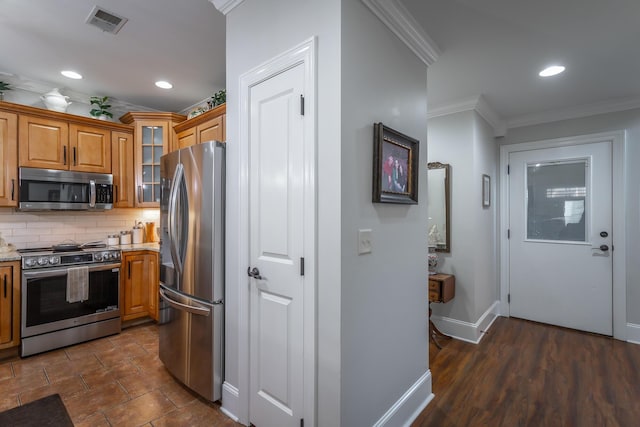 kitchen featuring decorative backsplash, light stone countertops, ornamental molding, and appliances with stainless steel finishes