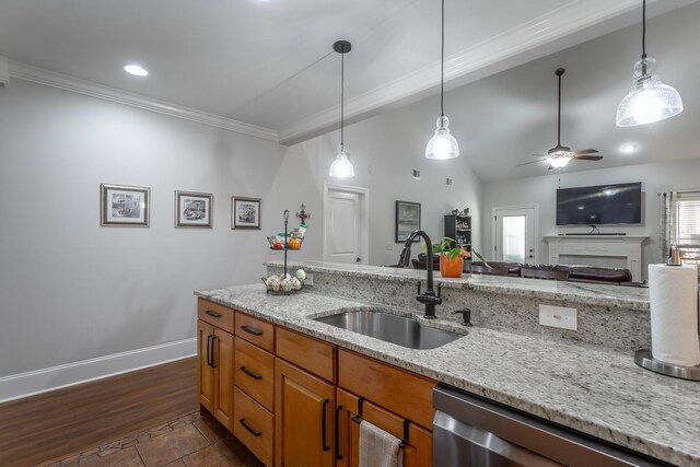 kitchen featuring light stone countertops, ceiling fan, sink, decorative light fixtures, and dishwasher