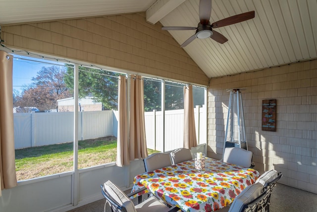 sunroom / solarium featuring lofted ceiling with beams and ceiling fan