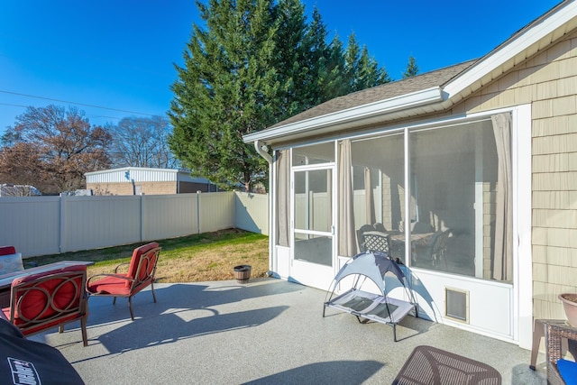 view of patio featuring a sunroom