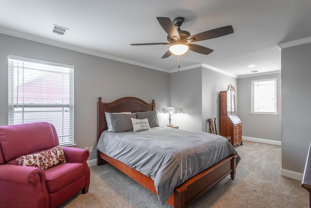 bedroom with multiple windows, ceiling fan, light colored carpet, and ornamental molding