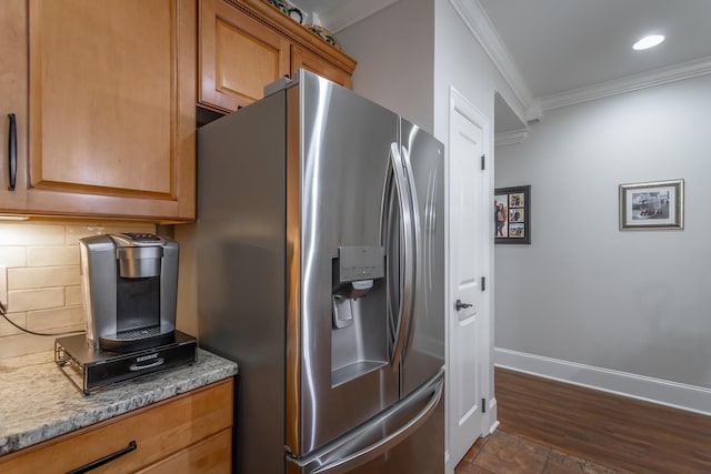 kitchen featuring decorative backsplash, stainless steel fridge with ice dispenser, light stone countertops, and ornamental molding