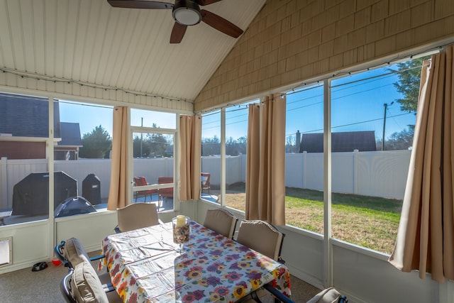 sunroom / solarium with ceiling fan and vaulted ceiling