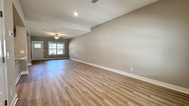 empty room with ceiling fan and light hardwood / wood-style floors