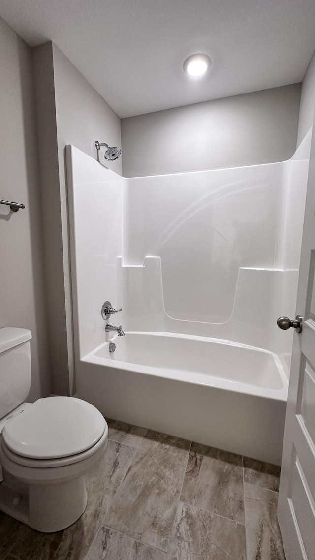 bathroom featuring toilet and bathtub / shower combination