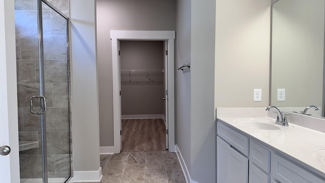 bathroom with vanity and a shower with shower door