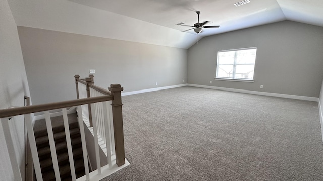 empty room with carpet flooring, ceiling fan, and vaulted ceiling