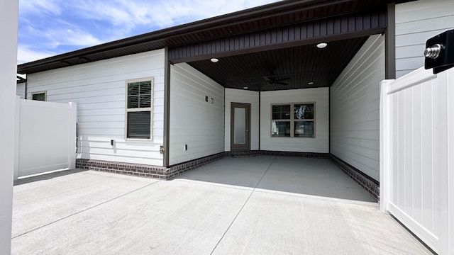 doorway to property featuring ceiling fan