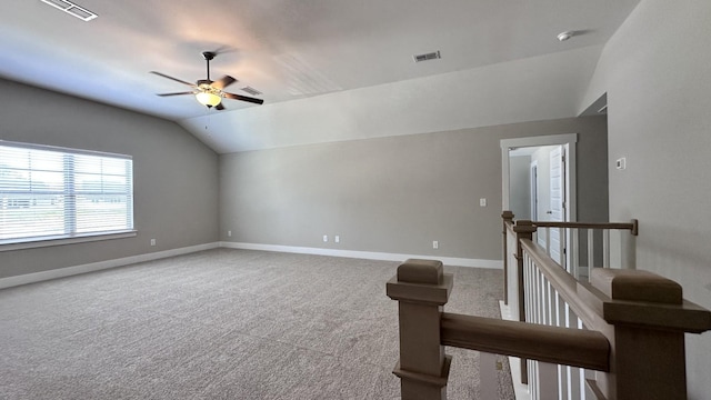 interior space with ceiling fan, carpet floors, and lofted ceiling