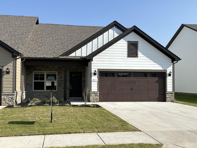 craftsman house featuring a front yard and a garage