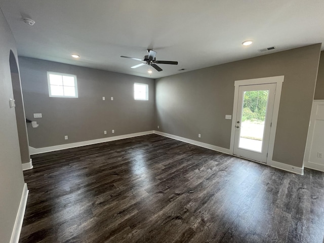 interior space with ceiling fan and dark hardwood / wood-style flooring