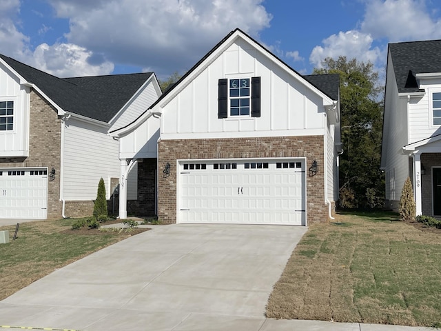 view of front of property with a front yard and a garage