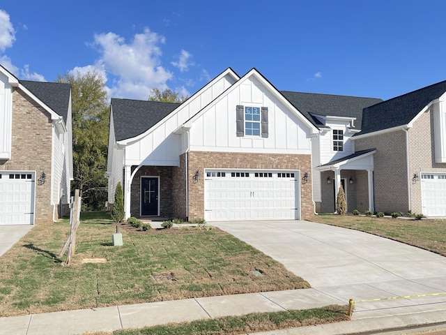 view of front of house featuring a garage and a front lawn