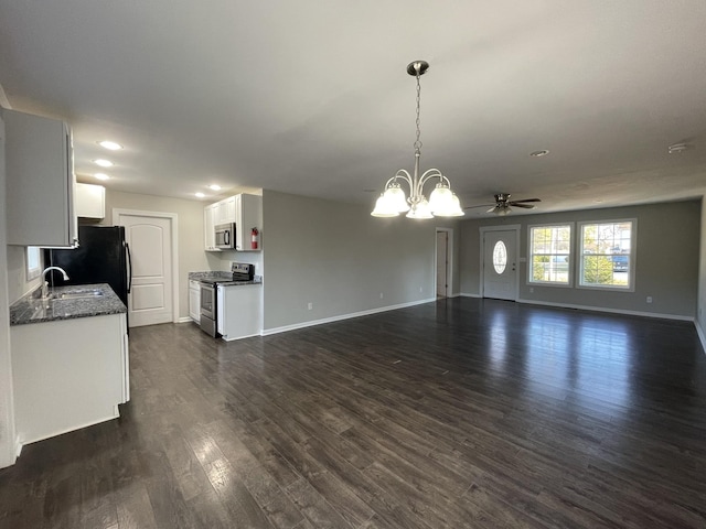 interior space with ceiling fan with notable chandelier, dark hardwood / wood-style flooring, and sink