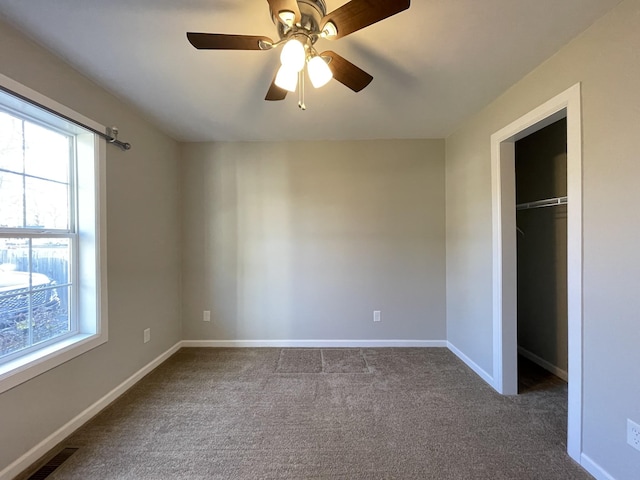 unfurnished bedroom featuring ceiling fan, light carpet, and a closet