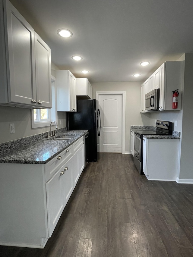 kitchen featuring appliances with stainless steel finishes, white cabinetry, and dark wood-type flooring