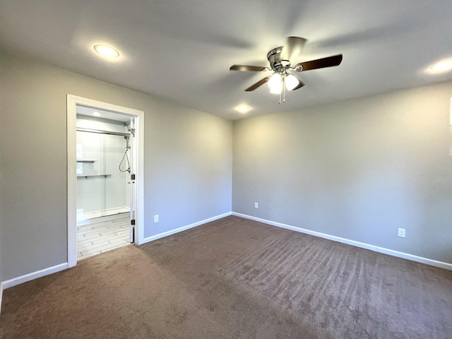 carpeted empty room featuring ceiling fan