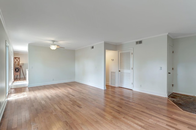 empty room featuring crown molding, ceiling fan, and light hardwood / wood-style floors