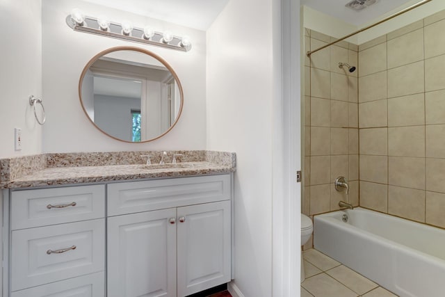 full bathroom with tile patterned flooring, vanity, toilet, and tiled shower / bath combo