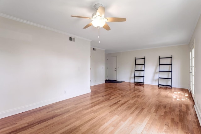 spare room featuring light wood-type flooring, ceiling fan, and ornamental molding