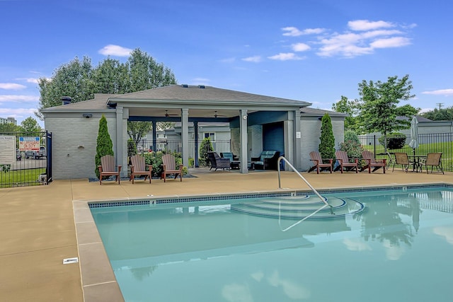 view of pool with ceiling fan and a patio