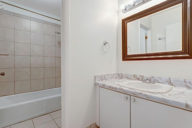 bathroom with tile patterned flooring, vanity, and tiled shower / bath combo