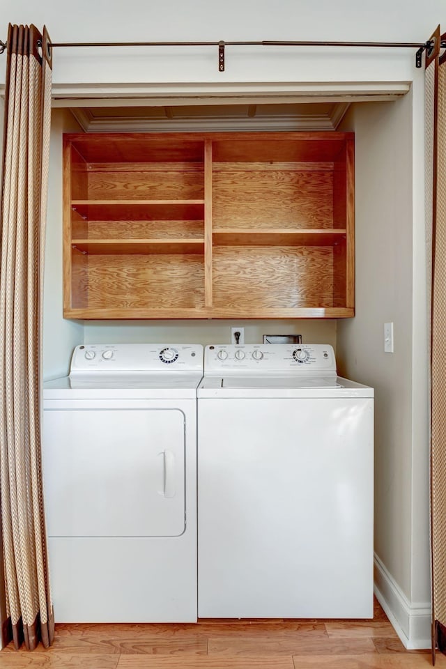 washroom featuring light hardwood / wood-style flooring and washer and dryer