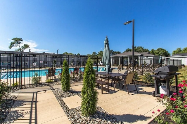 view of patio featuring grilling area and a community pool